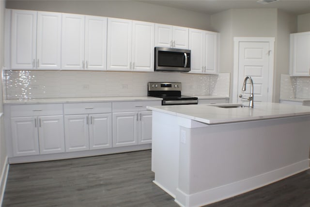 kitchen featuring dark hardwood / wood-style flooring, sink, white cabinets, and stainless steel appliances