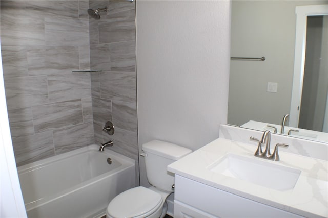 full bathroom featuring vanity, tiled shower / bath combo, and toilet