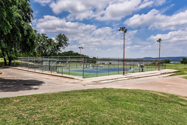 view of home's community featuring a lawn, tennis court, a rural view, and a mountain view