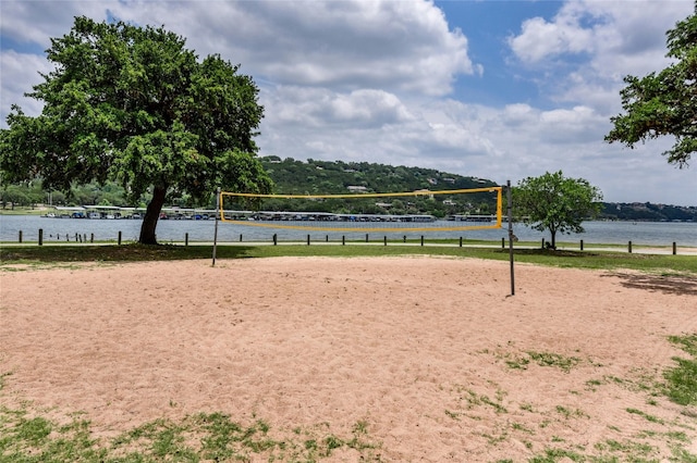 surrounding community featuring a water view and volleyball court