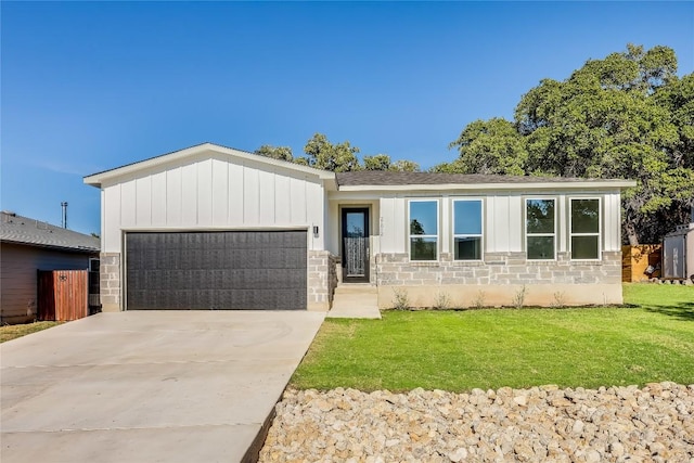 view of front of property with a garage and a front lawn