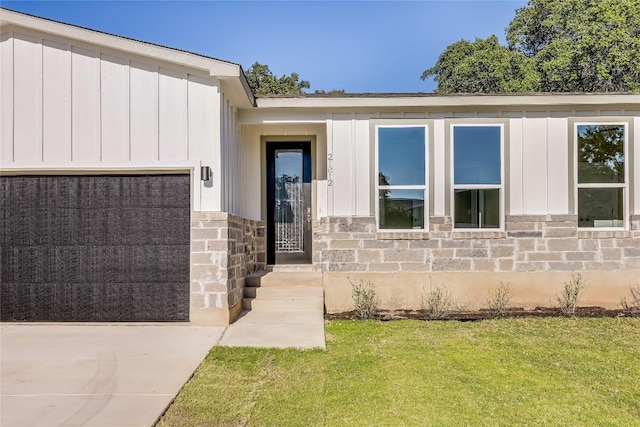 view of exterior entry featuring a yard