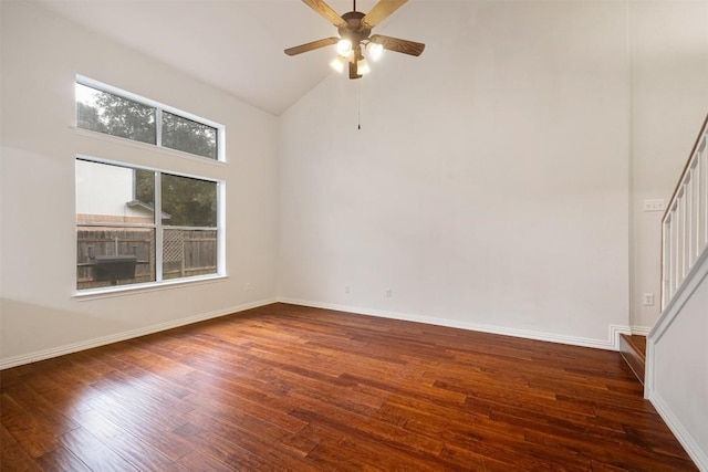 empty room with ceiling fan, high vaulted ceiling, and dark wood-type flooring