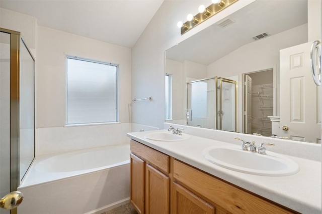 bathroom with plus walk in shower, vanity, and vaulted ceiling