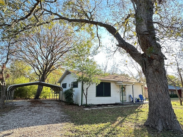 view of side of property featuring a carport