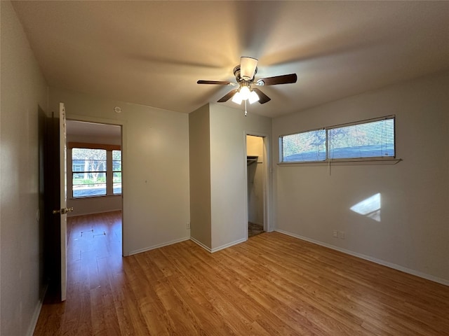 spare room with ceiling fan and light wood-type flooring