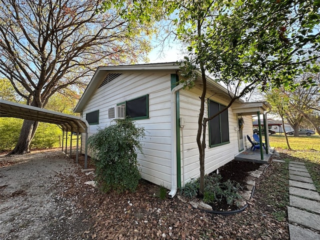 view of side of home with a carport