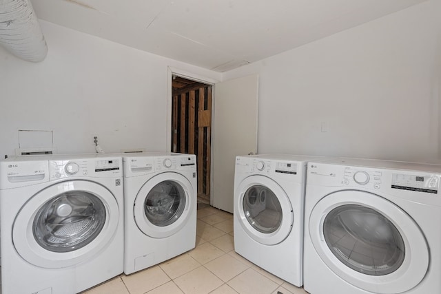 laundry area featuring light tile patterned flooring and separate washer and dryer