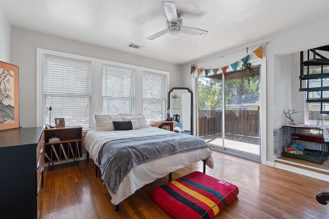 bedroom with ceiling fan, access to exterior, dark wood-type flooring, and multiple windows