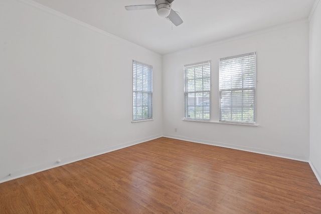 unfurnished room featuring hardwood / wood-style flooring, ceiling fan, and crown molding