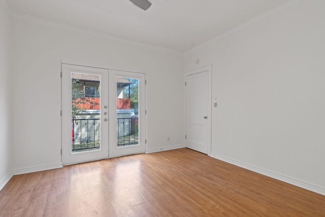 spare room featuring french doors, light wood-type flooring, ceiling fan, and crown molding