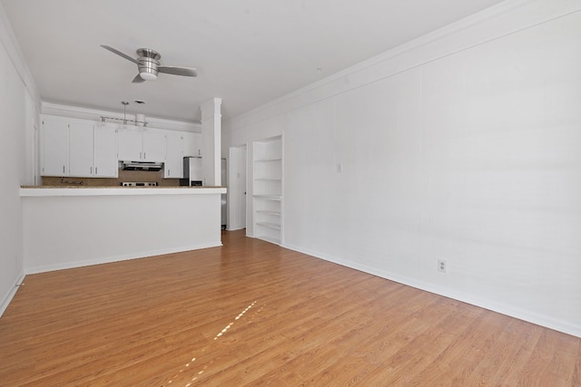 unfurnished living room featuring crown molding, ceiling fan, and light hardwood / wood-style floors