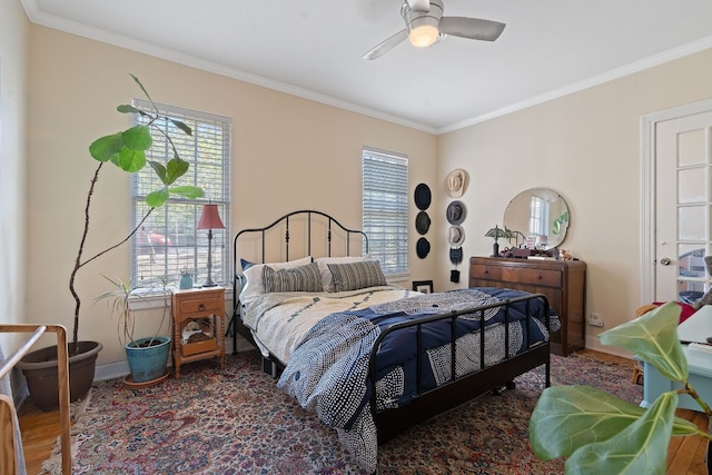 bedroom featuring multiple windows, ornamental molding, ceiling fan, and dark wood-type flooring