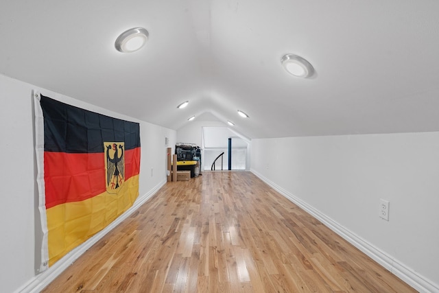 bonus room featuring wood-type flooring and vaulted ceiling