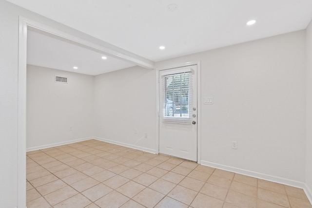 interior space featuring light tile patterned floors and beam ceiling