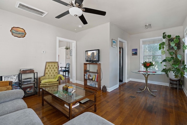 living room featuring dark hardwood / wood-style flooring and ceiling fan