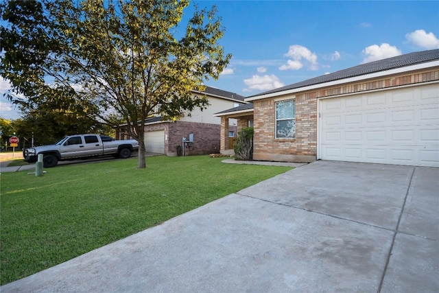 view of front of home with a front lawn and a garage