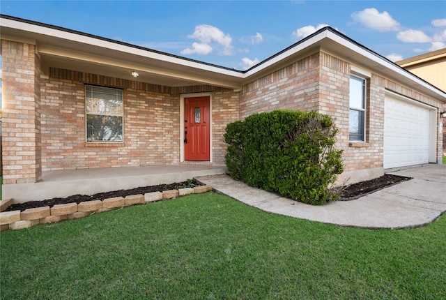 entrance to property with a lawn and a garage