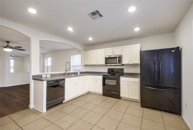 kitchen featuring black appliances, sink, ceiling fan, light tile patterned flooring, and white cabinetry