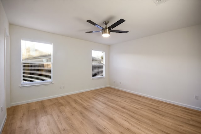 empty room with ceiling fan and light wood-type flooring