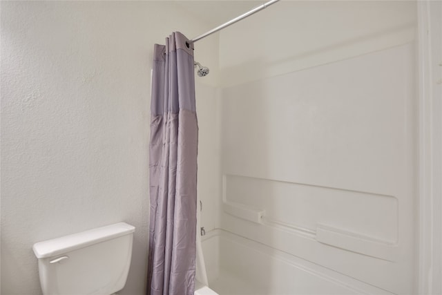 bathroom with toilet and shower / tub combo