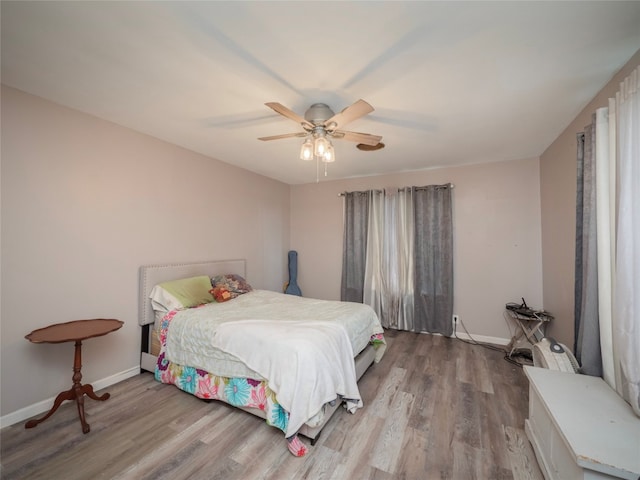 bedroom with hardwood / wood-style floors and ceiling fan