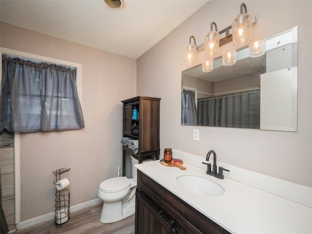 bathroom with hardwood / wood-style flooring, vanity, toilet, and a shower with curtain