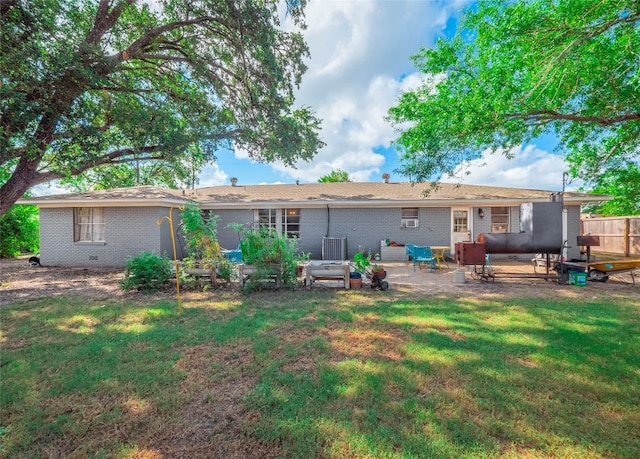 back of house featuring a yard and a patio