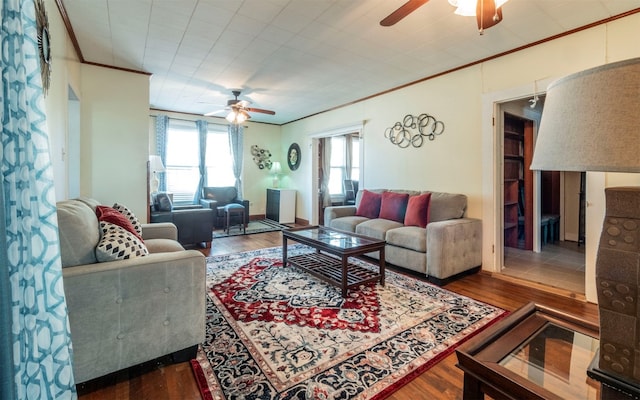 living room featuring ceiling fan, ornamental molding, and hardwood / wood-style flooring