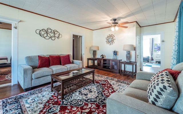 living room with ceiling fan, dark hardwood / wood-style flooring, and crown molding