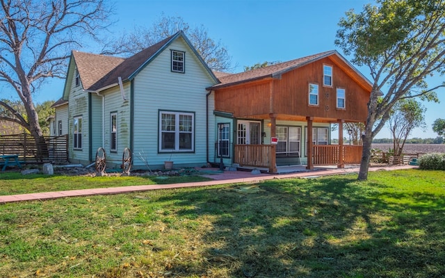 rear view of property with a lawn