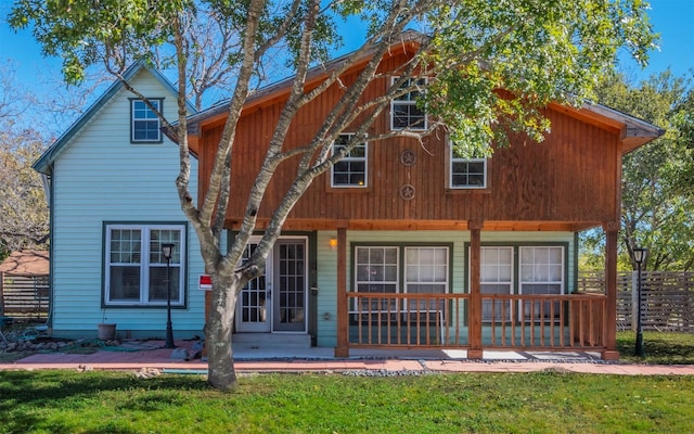 rear view of property with a yard