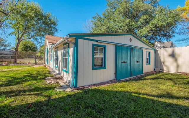 view of outbuilding with a yard