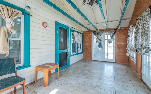 sunroom featuring french doors and lofted ceiling with beams