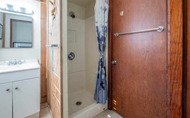 bathroom with tile patterned flooring, vanity, and curtained shower