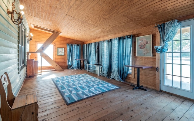 interior space featuring wood walls, wood ceiling, and light hardwood / wood-style flooring