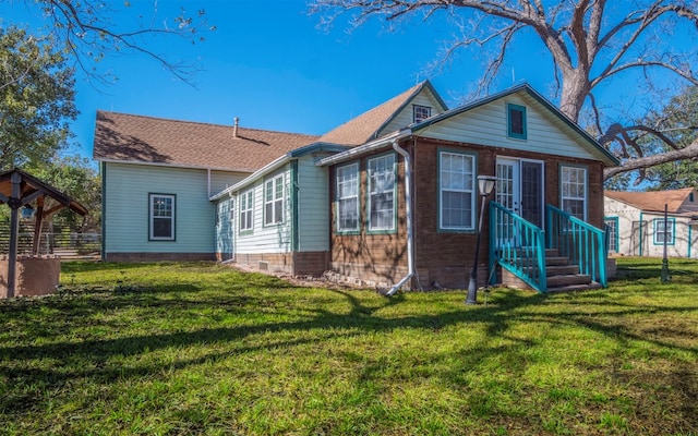 rear view of property with a lawn