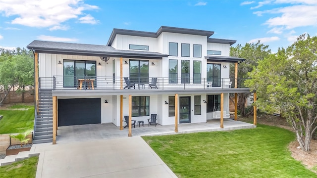 contemporary home featuring a garage, a balcony, a patio, and a front lawn