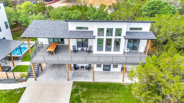 rear view of house with a yard and a wooden deck