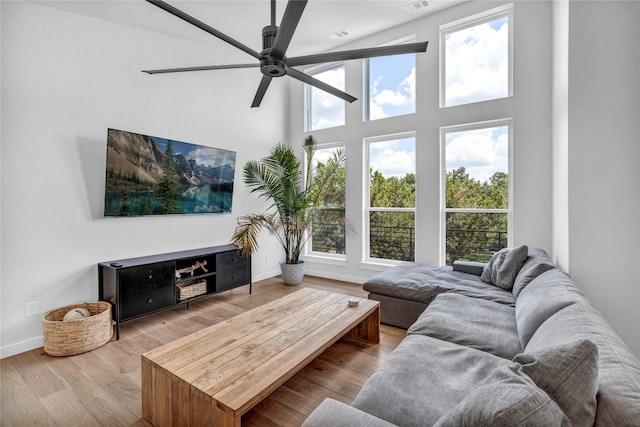 living room with ceiling fan and light hardwood / wood-style floors