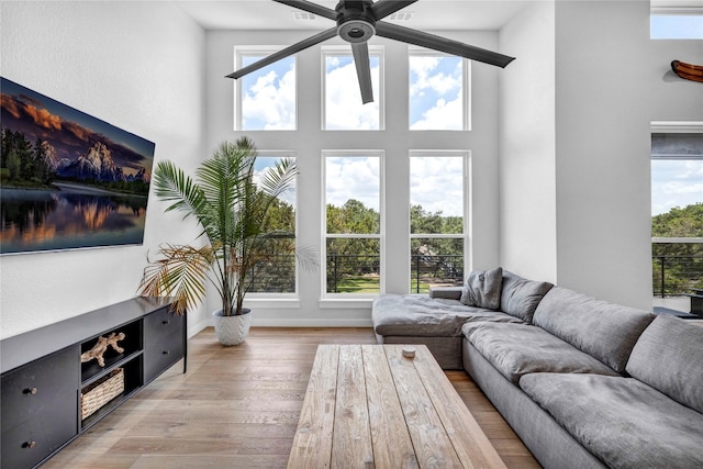 sunroom featuring a wealth of natural light and ceiling fan