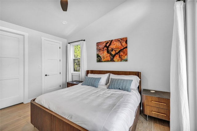 bedroom with light wood-type flooring, ceiling fan, and lofted ceiling