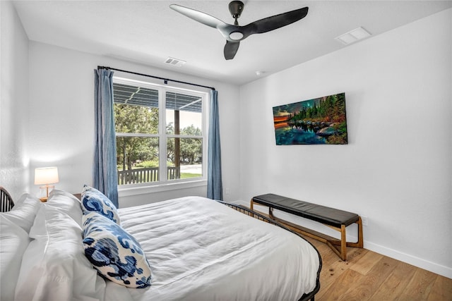 bedroom with ceiling fan and hardwood / wood-style flooring