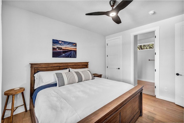 bedroom with ceiling fan and light hardwood / wood-style floors