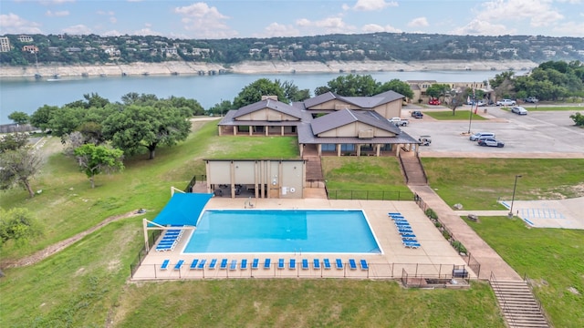 view of swimming pool with a water view