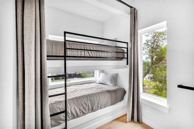 bedroom with multiple windows and light hardwood / wood-style flooring