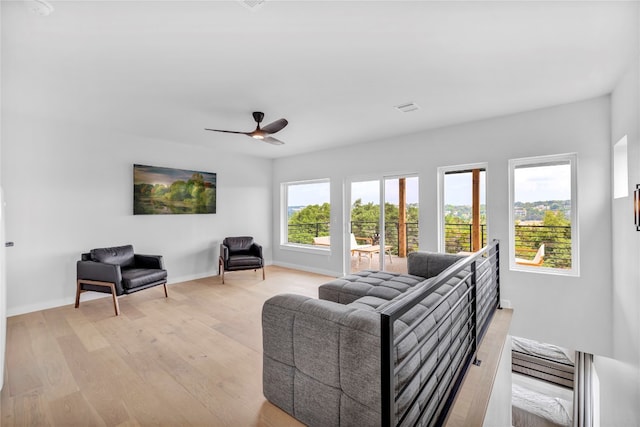 living room featuring ceiling fan and light hardwood / wood-style floors