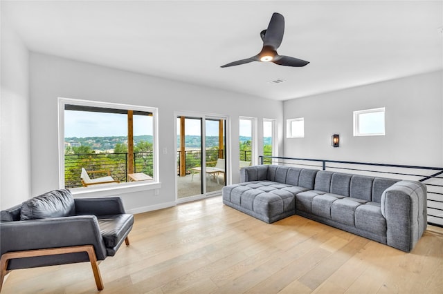 living room featuring ceiling fan and light hardwood / wood-style floors