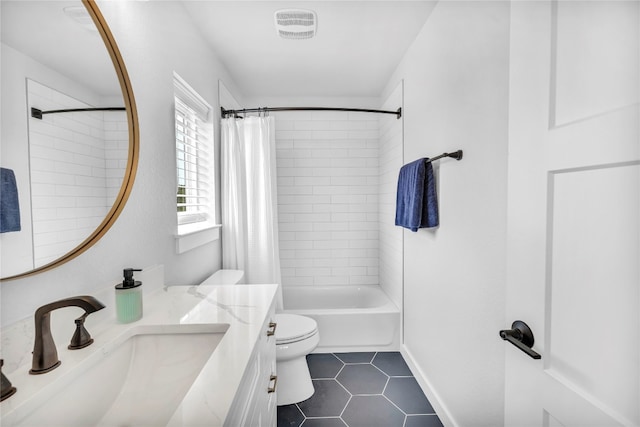 full bathroom featuring tile patterned floors, vanity, toilet, and shower / bath combo with shower curtain