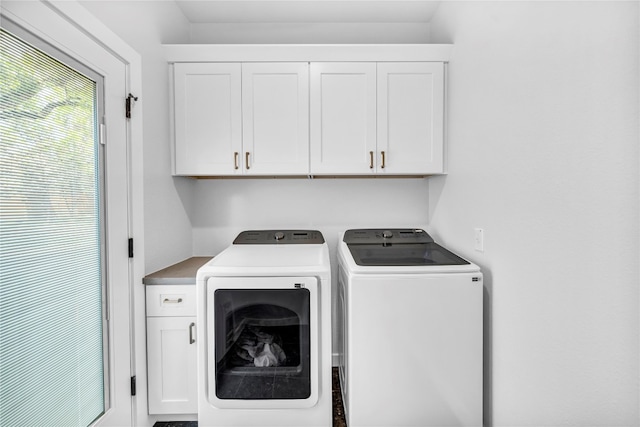 washroom featuring cabinets and independent washer and dryer